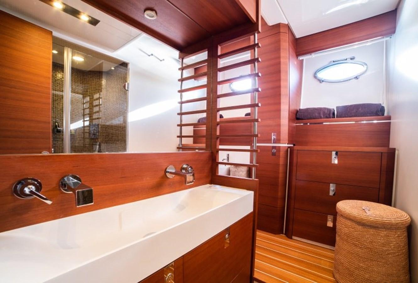 a bathroom with a tub sink and mirror aboard BLUE MAMBA Yacht for Sale