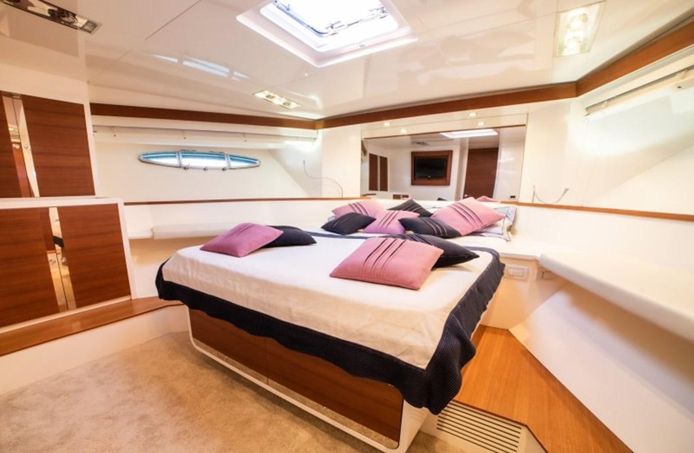 a room with a bed and a window aboard BLUE MAMBA Yacht for Sale