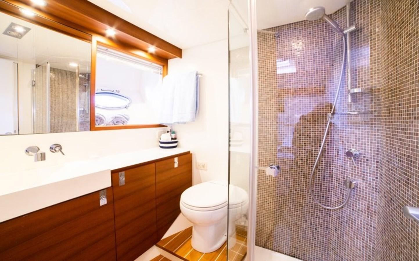 a bathroom with a glass shower aboard BLUE MAMBA Yacht for Sale