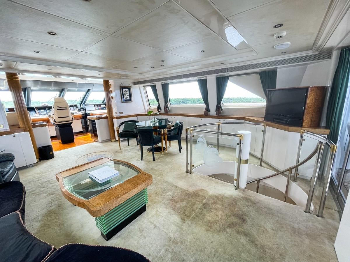 a room with tables and chairs aboard OBSESSIONS Yacht for Sale