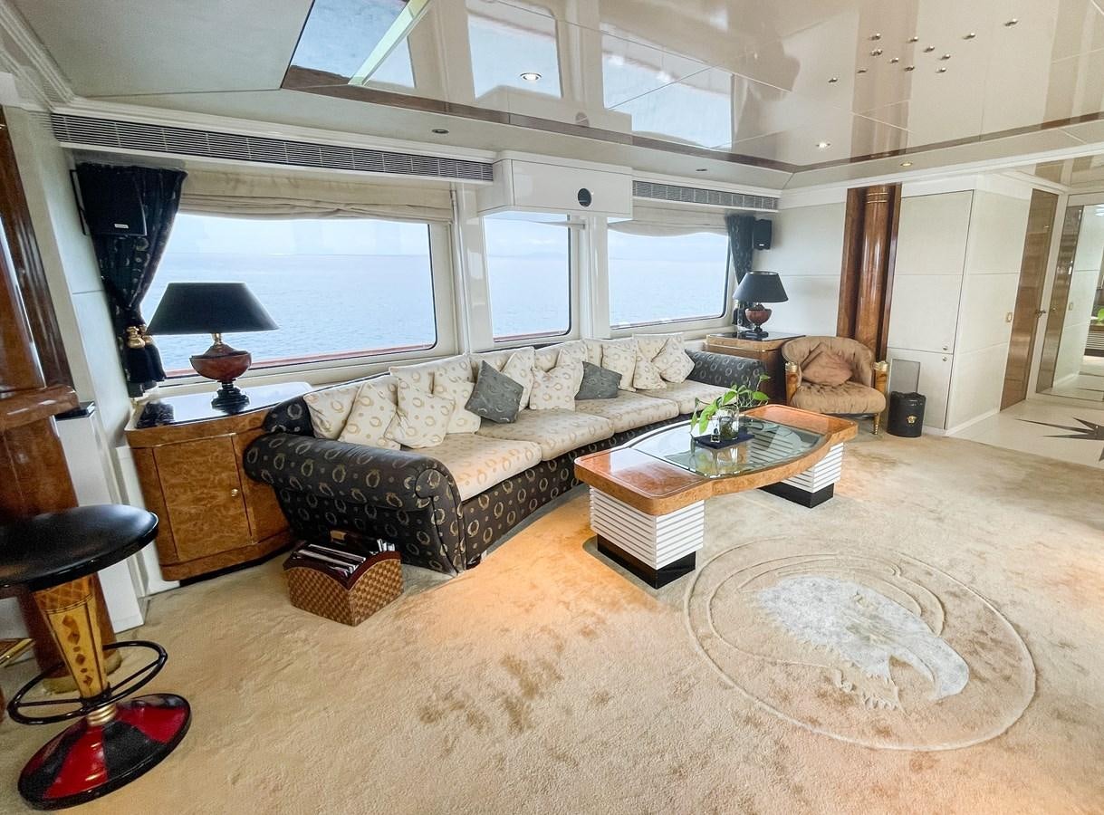 a living room with a couch and a coffee table aboard OBSESSIONS Yacht for Sale