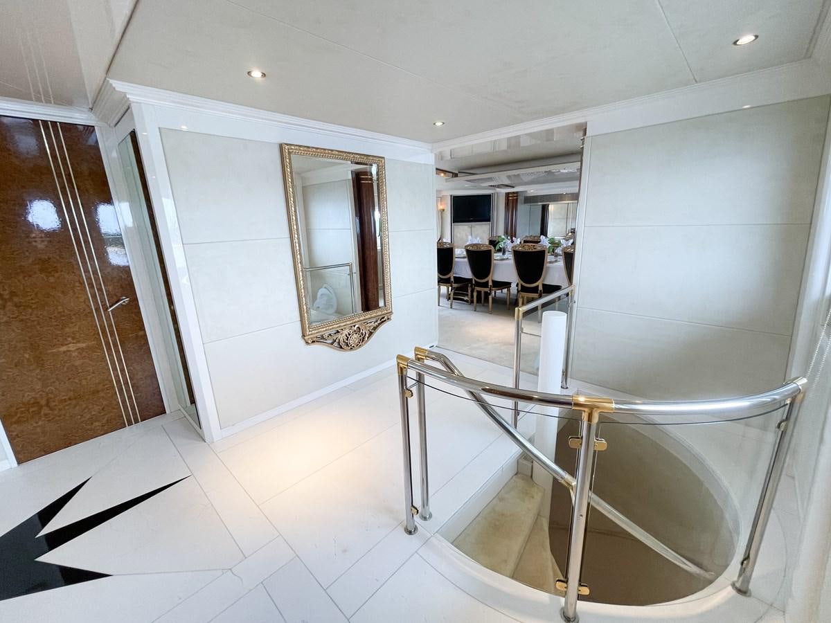 a large white room with a glass table and chairs aboard OBSESSIONS Yacht for Sale