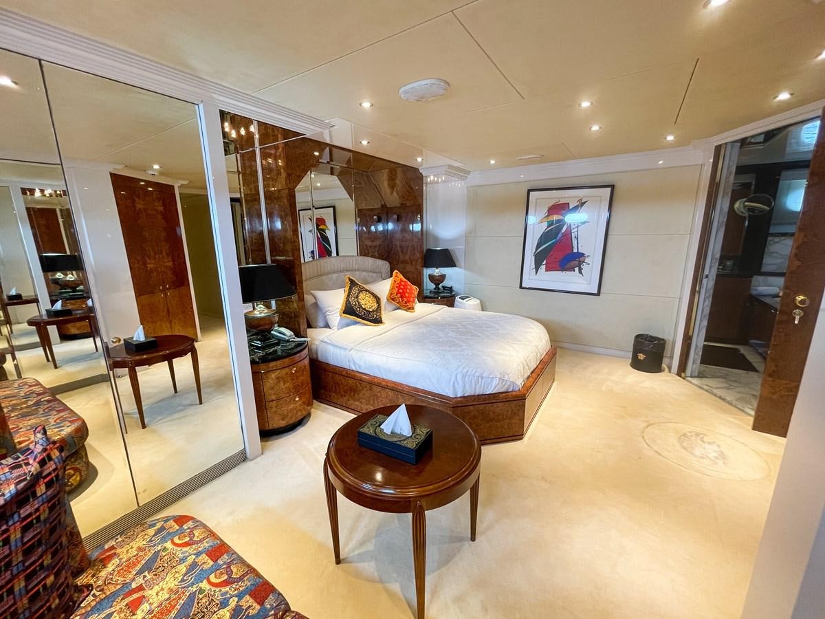 a living room with a couch and a table aboard OBSESSIONS Yacht for Sale