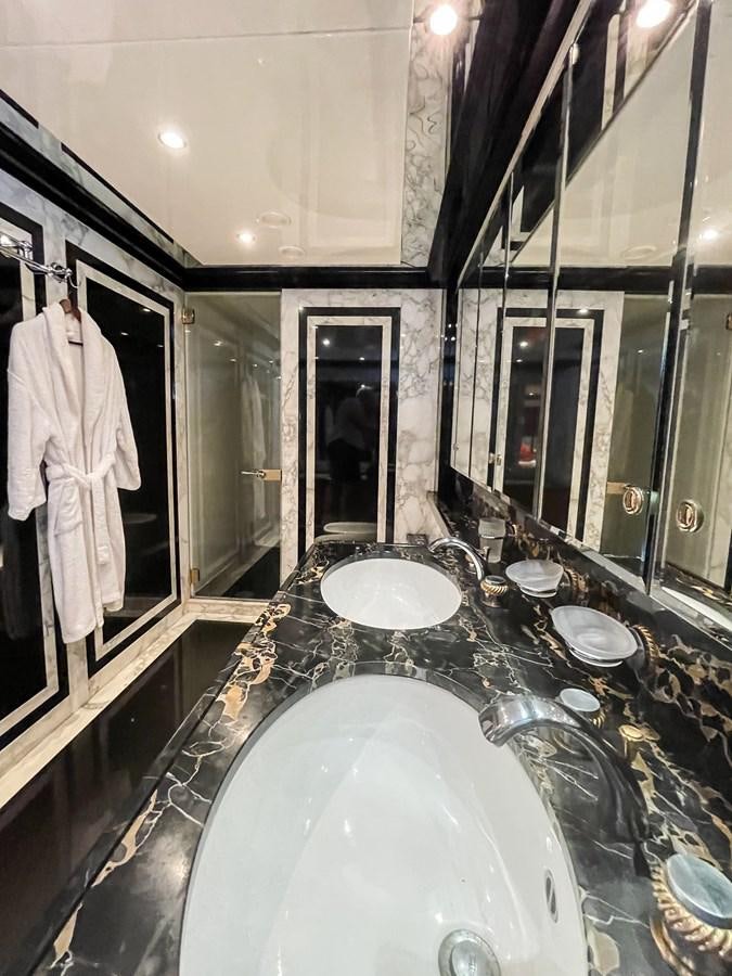 a bathroom with a large marble counter aboard OBSESSIONS Yacht for Sale