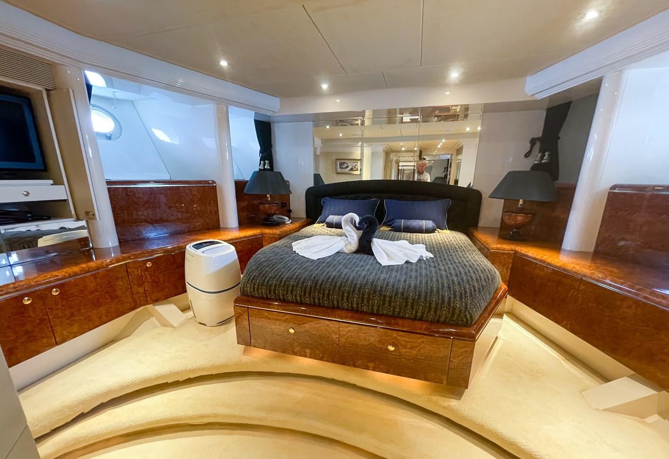 a large bedroom with a large bed aboard OBSESSIONS Yacht for Sale