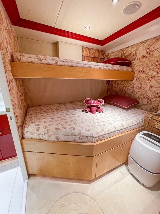 a pink stuffed animal on a bed aboard OBSESSIONS Yacht for Sale