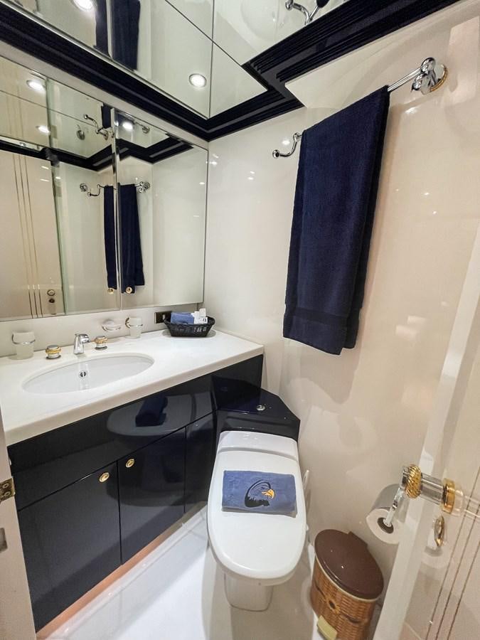 a bathroom with a toilet and sink aboard OBSESSIONS Yacht for Sale
