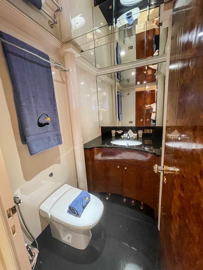 a bathroom with a toilet and a sink aboard OBSESSIONS Yacht for Sale