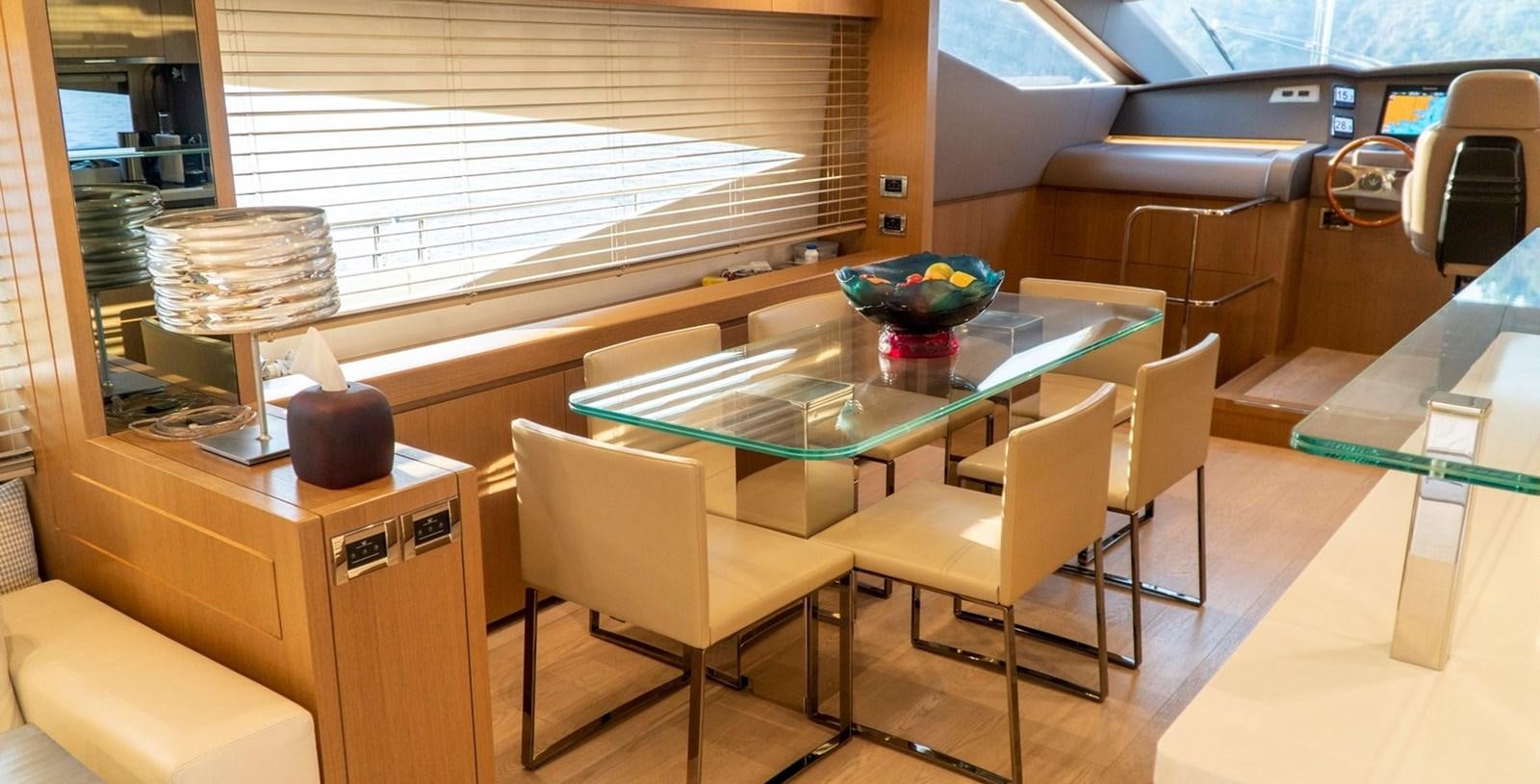 a room with a table and chairs aboard DOLLY Yacht for Sale