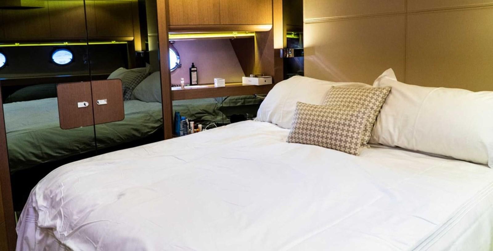 a bed with white sheets aboard DOLLY Yacht for Sale