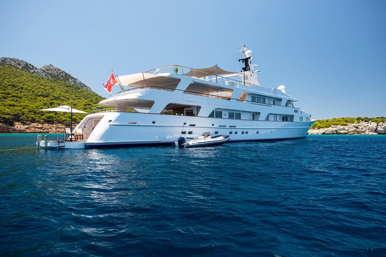 a large white boat on the water aboard ILLUSION I Yacht for Sale