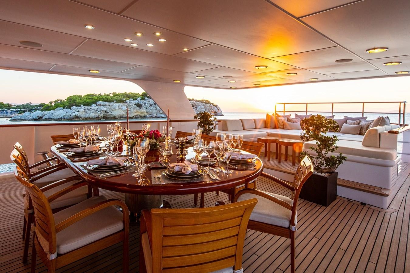 a dining table in a room aboard ILLUSION I Yacht for Sale