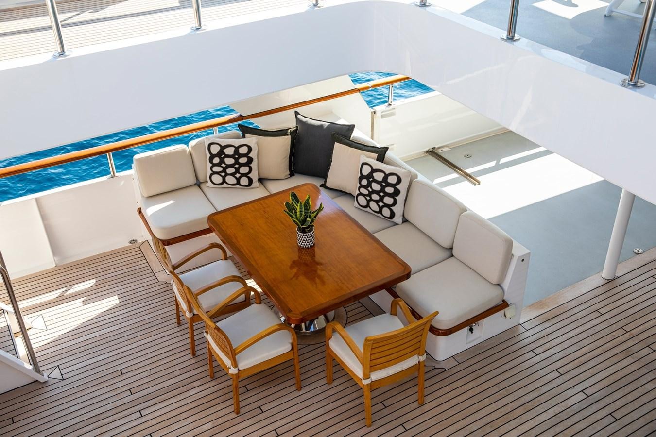 a room with a couch and a table and chairs aboard ILLUSION I Yacht for Sale