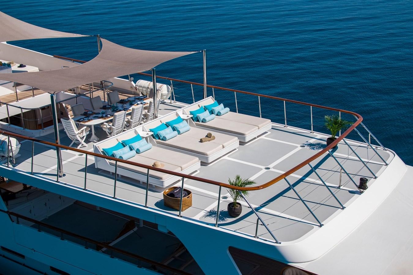 a large white boat on the water aboard ILLUSION I Yacht for Sale