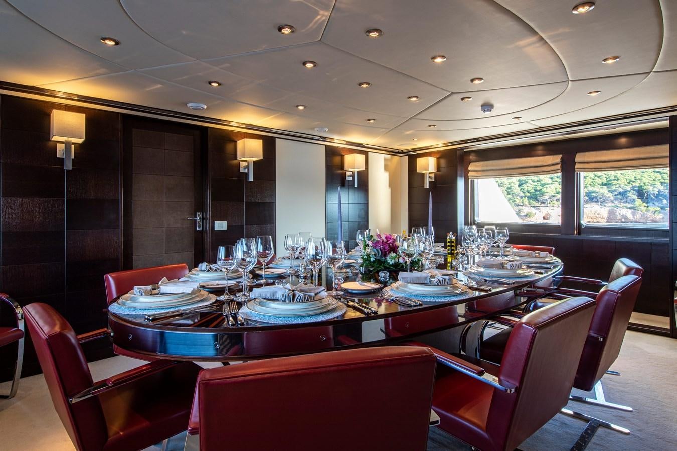 a restaurant with tables and chairs aboard ILLUSION I Yacht for Sale