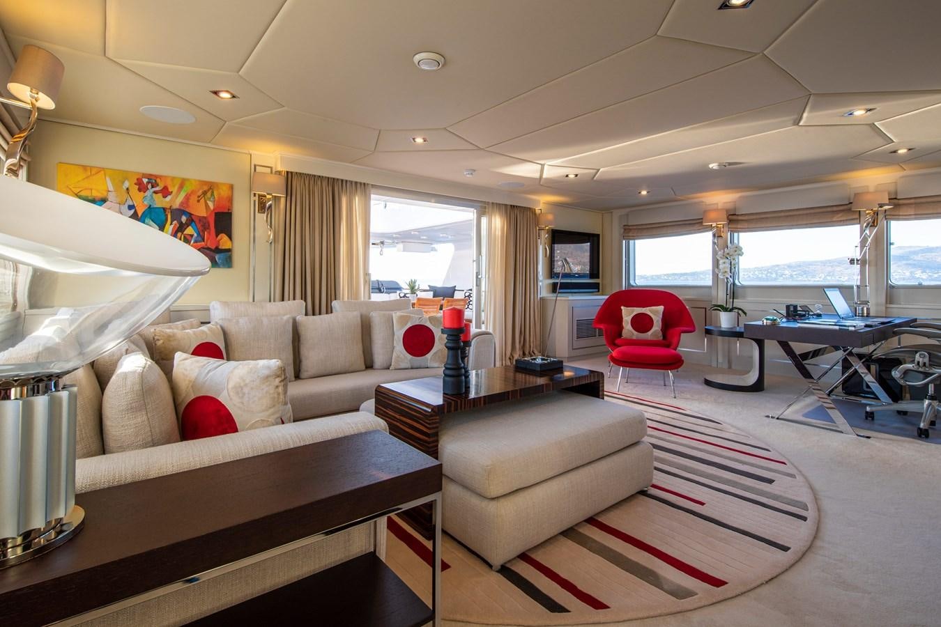 a living room with a couch and a table aboard ILLUSION I Yacht for Sale