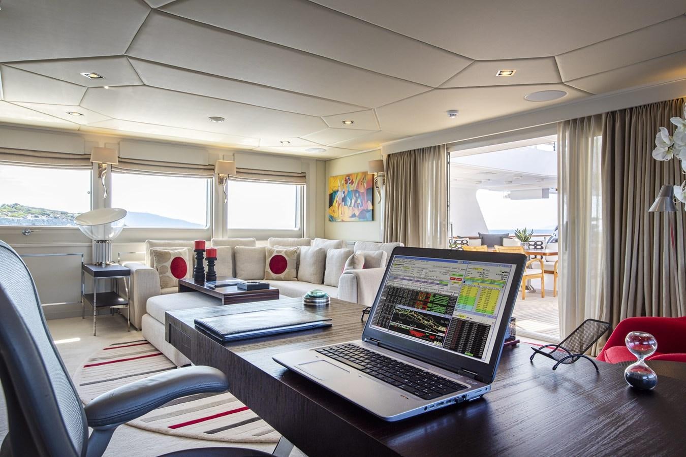 a laptop on a table aboard ILLUSION I Yacht for Sale