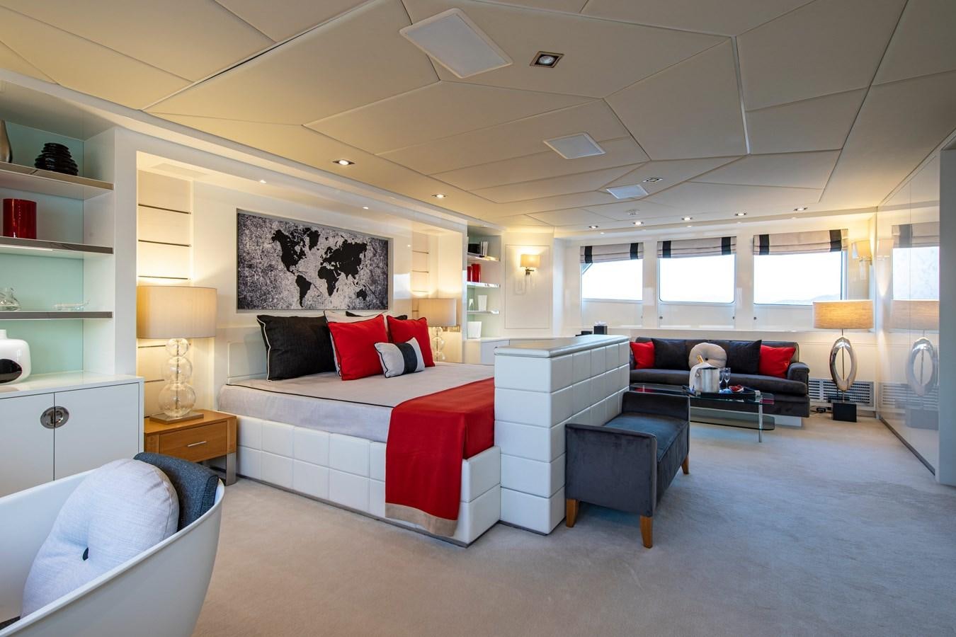 a bedroom with a bed and a couch aboard ILLUSION I Yacht for Sale