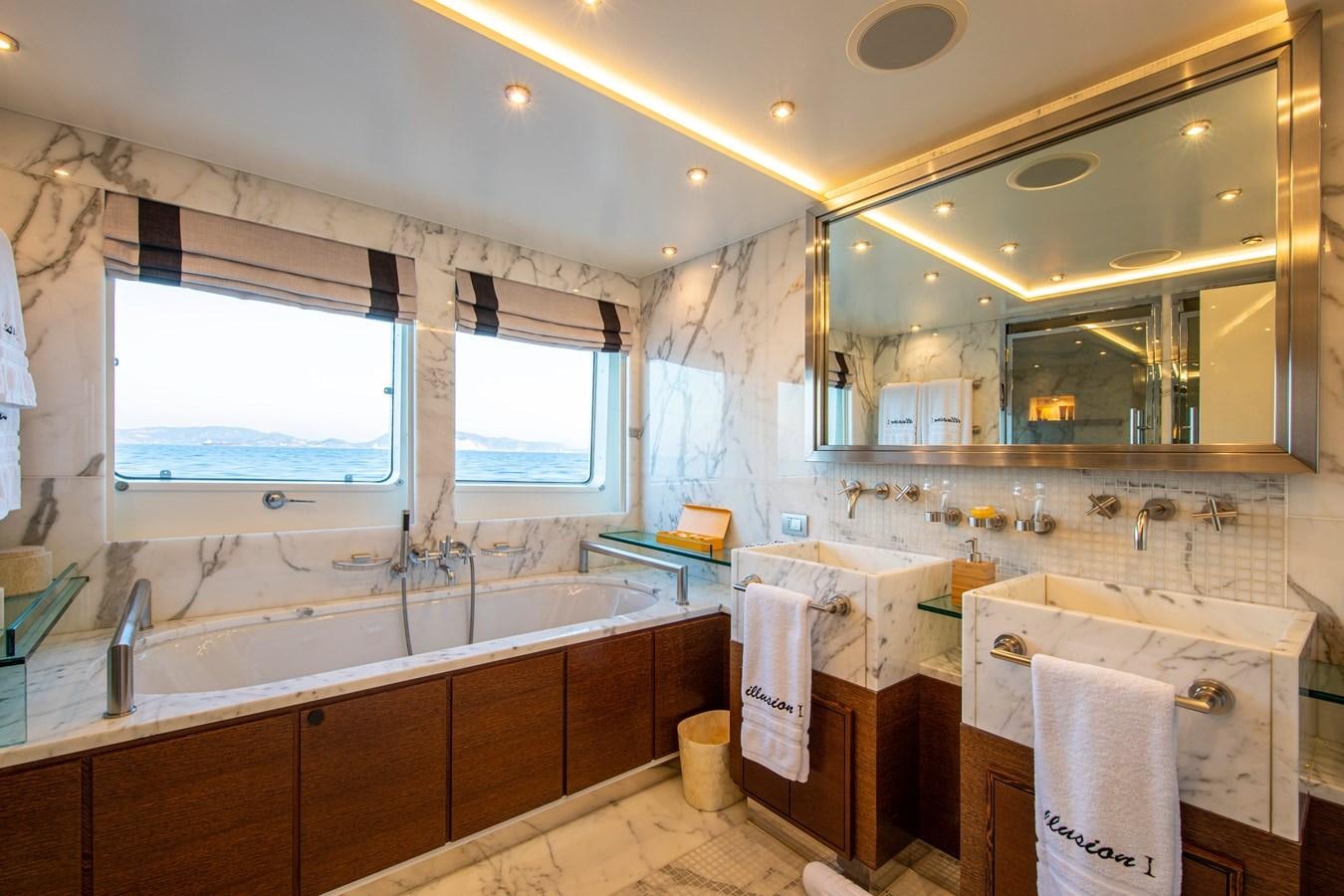 a bathroom with a large mirror aboard ILLUSION I Yacht for Sale
