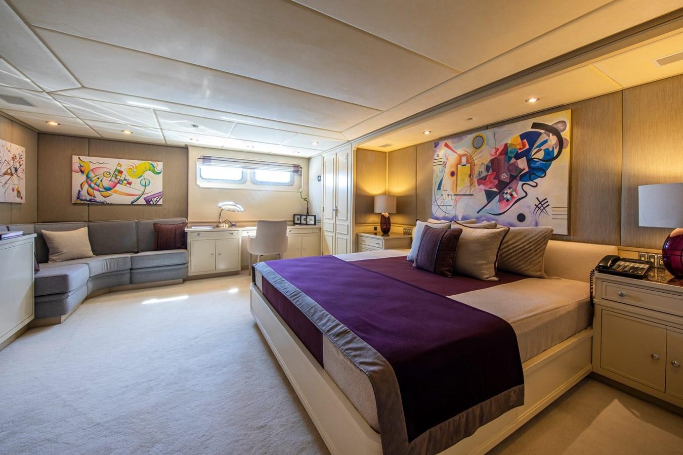 a large bedroom with a bed and a couch aboard ILLUSION I Yacht for Sale