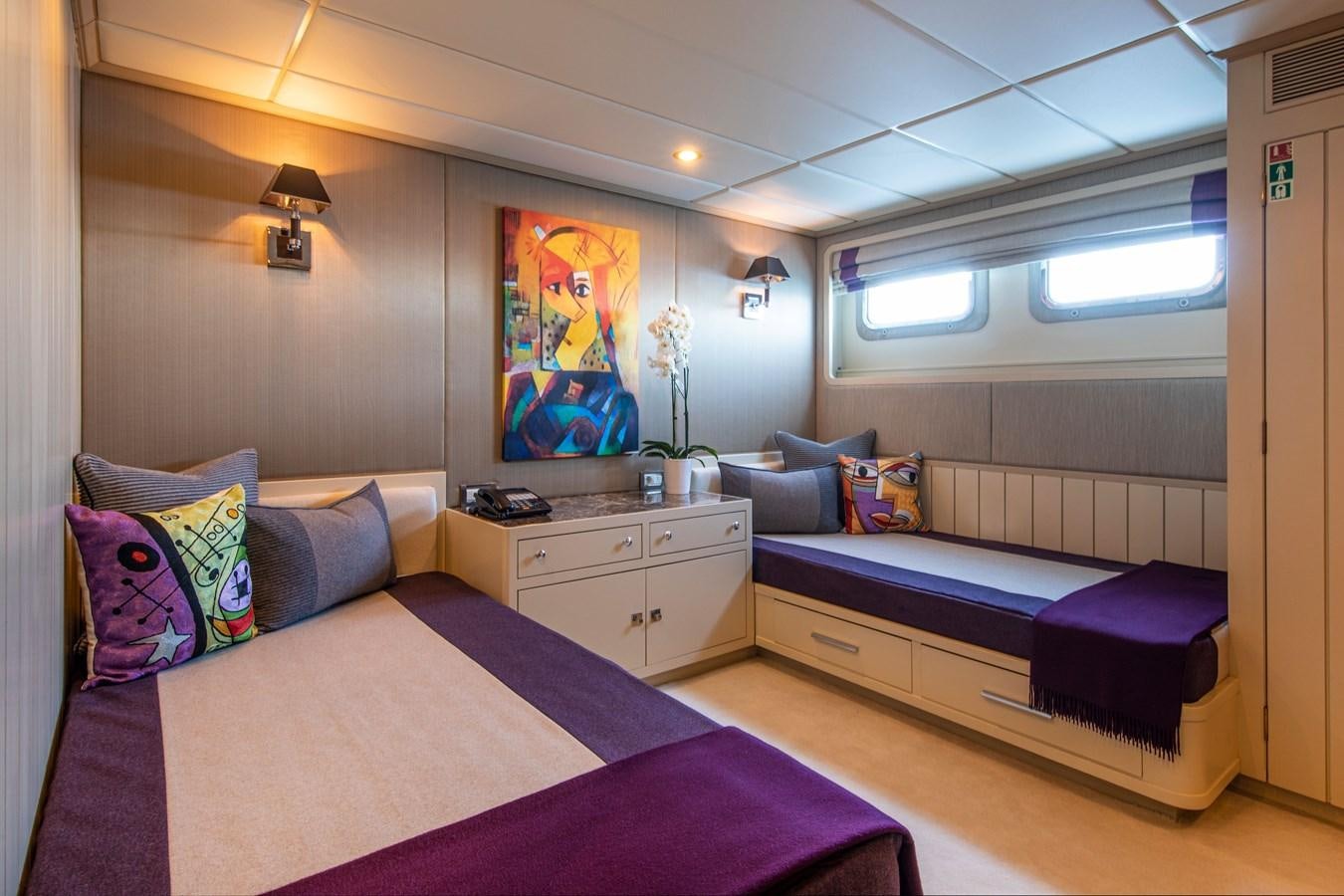 a bedroom with two beds aboard ILLUSION I Yacht for Sale