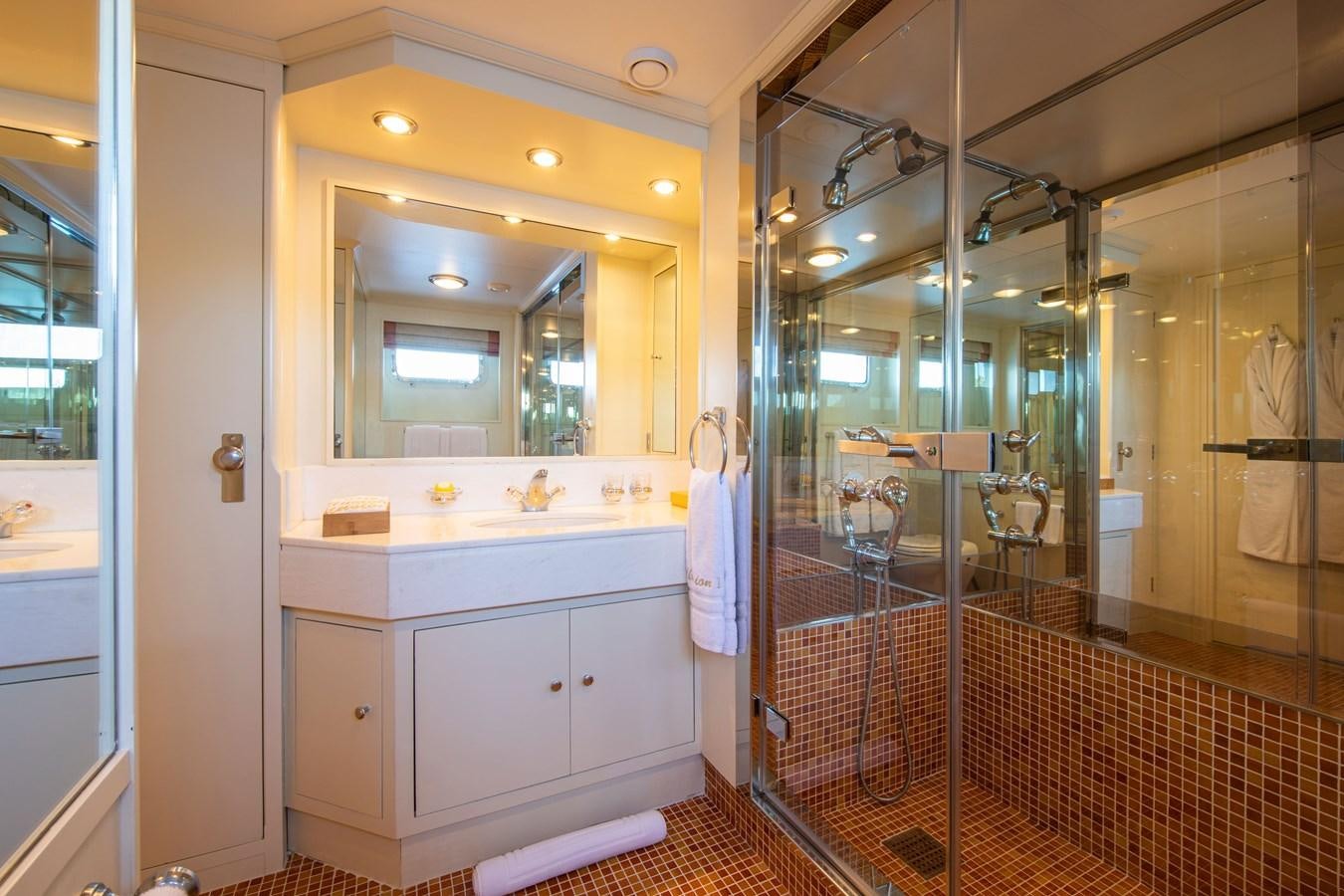 a bathroom with a shower unit and sink aboard ILLUSION I Yacht for Sale