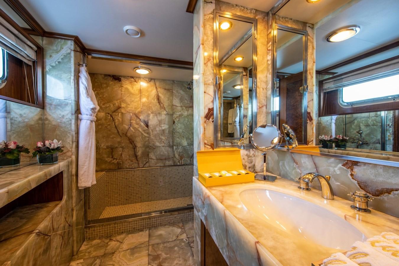a bathroom with a large marble shower aboard ILLUSION I Yacht for Sale