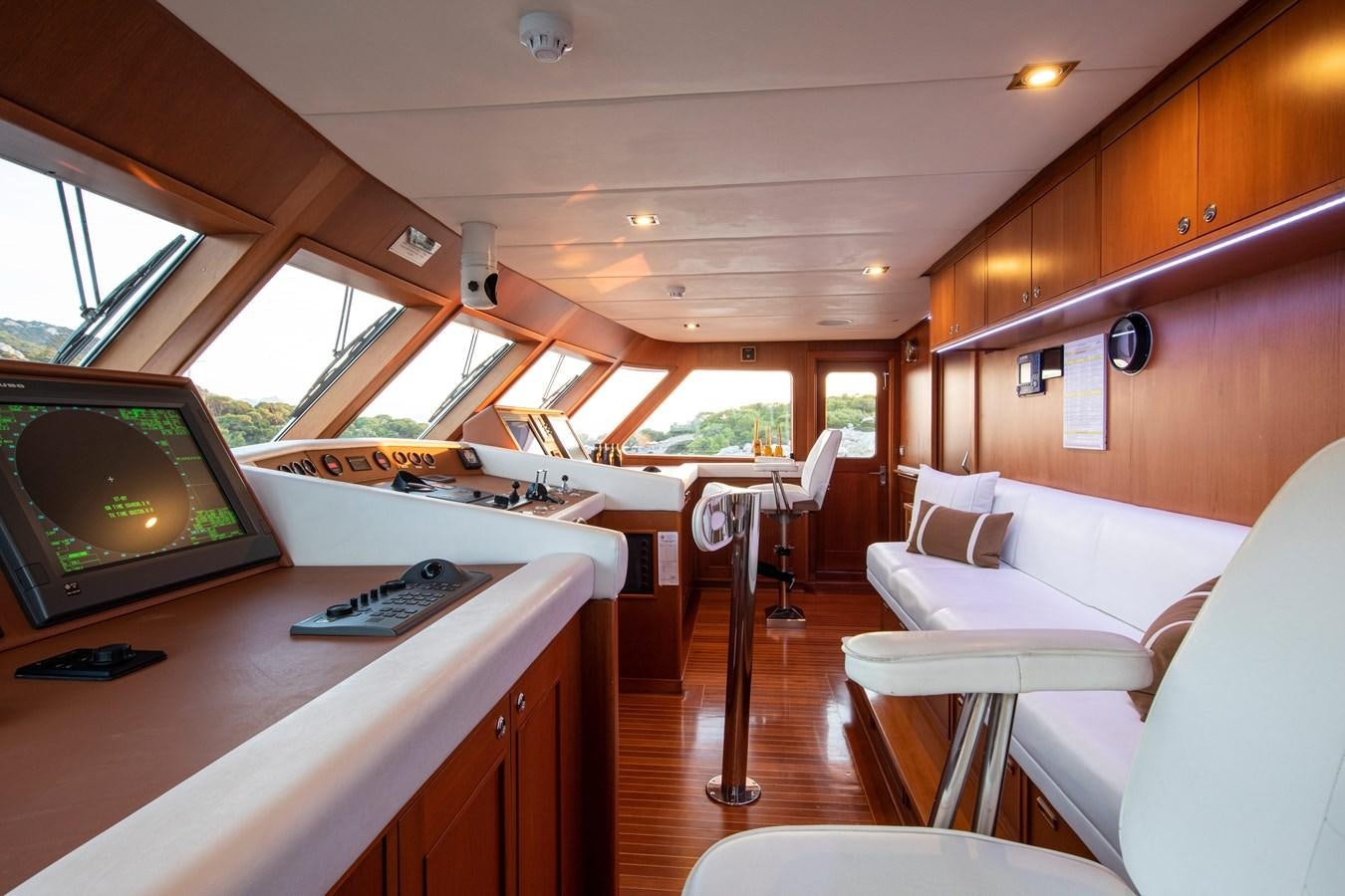 a room with a couch and a television aboard ILLUSION I Yacht for Sale