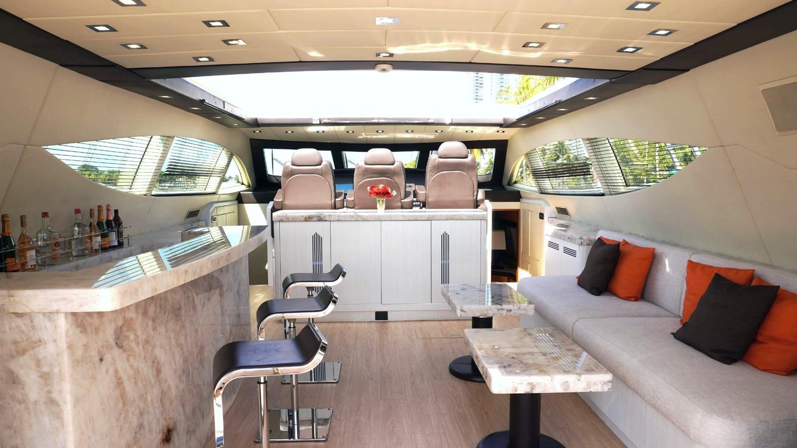 a room with a couch and a table and chairs aboard DAYA Yacht for Sale