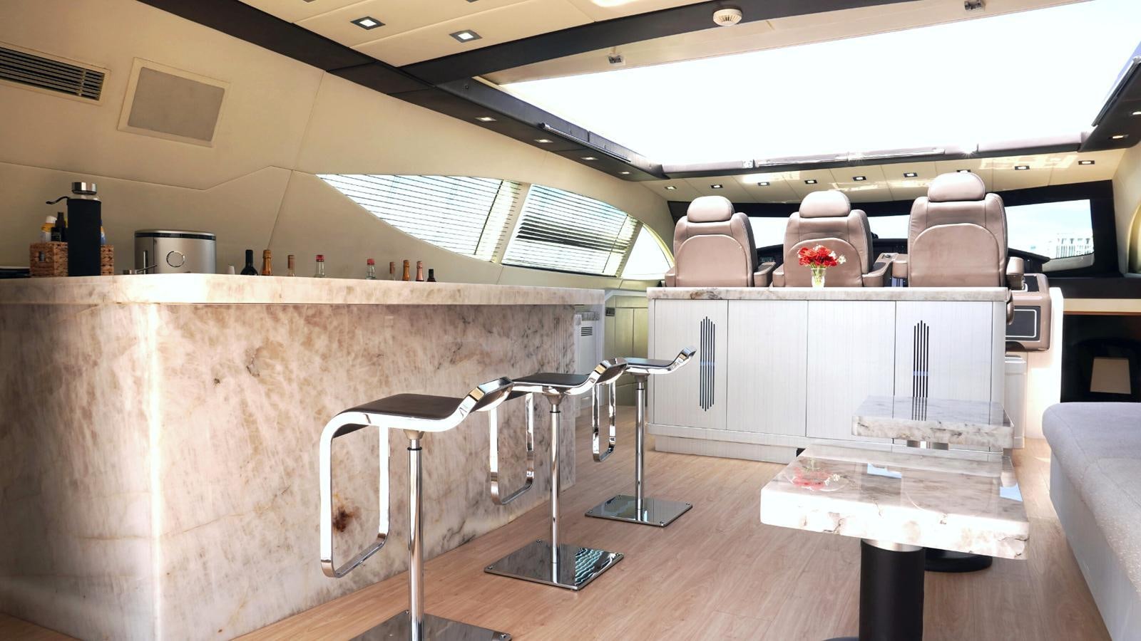 a room with a table and chairs aboard DAYA Yacht for Sale