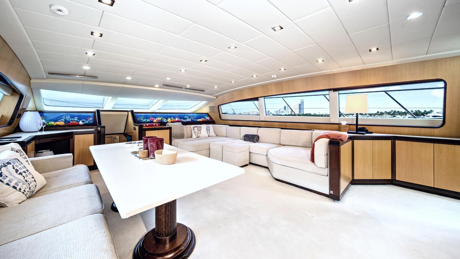 a living room with a table and couches aboard DAYA Yacht for Sale