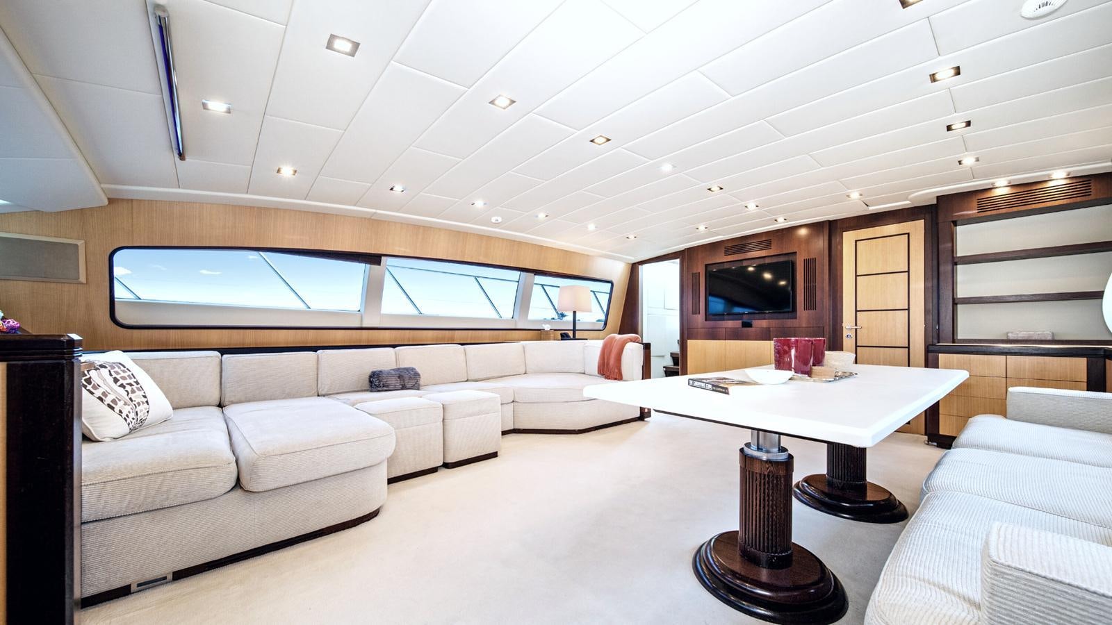 a living room with a couch and a table aboard DAYA Yacht for Sale