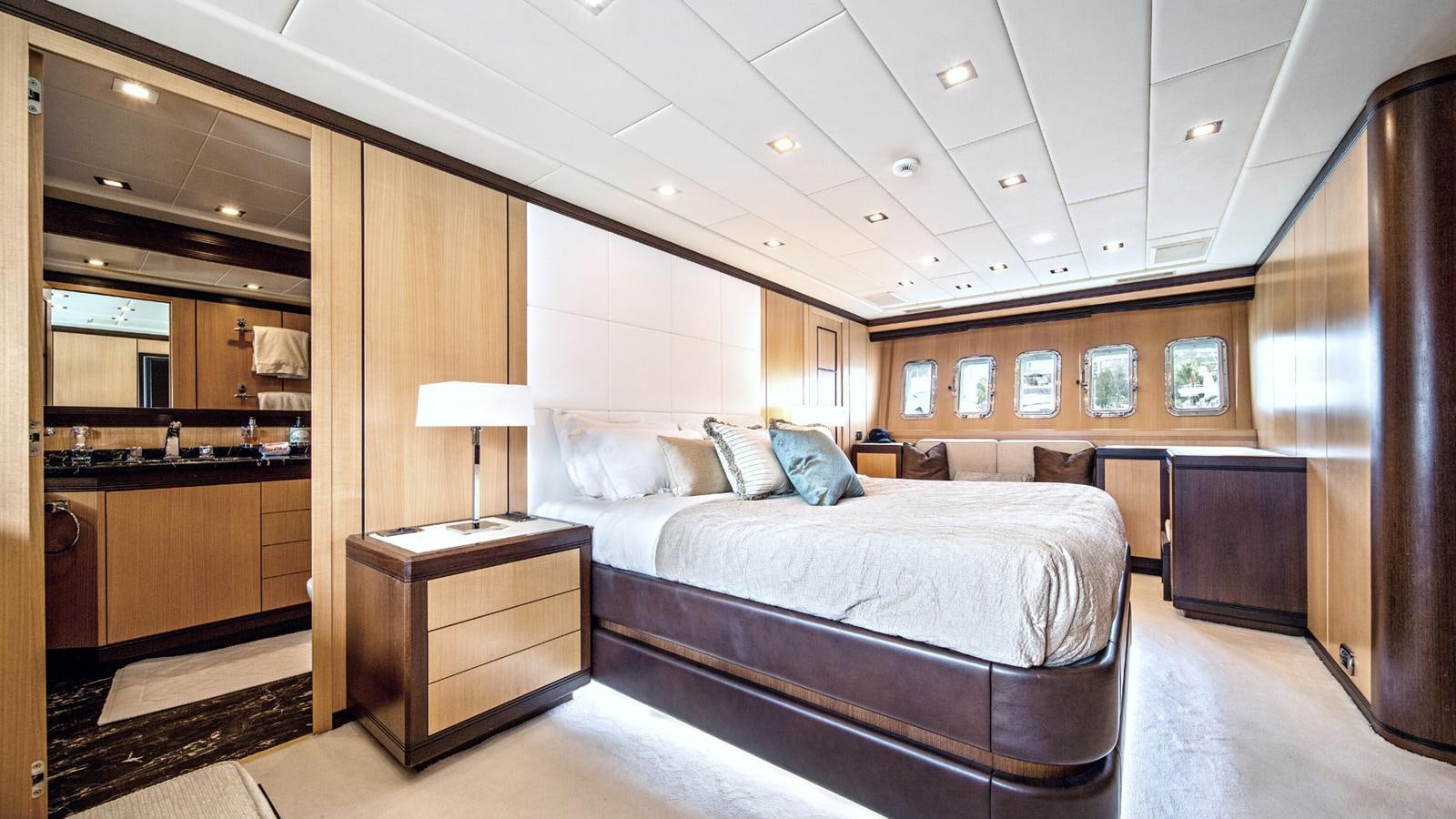 a bedroom with a bed and a desk aboard DAYA Yacht for Sale