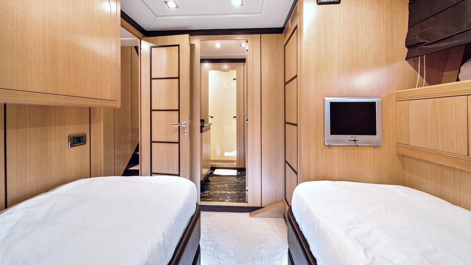 a room with a bed and a television aboard DAYA Yacht for Sale