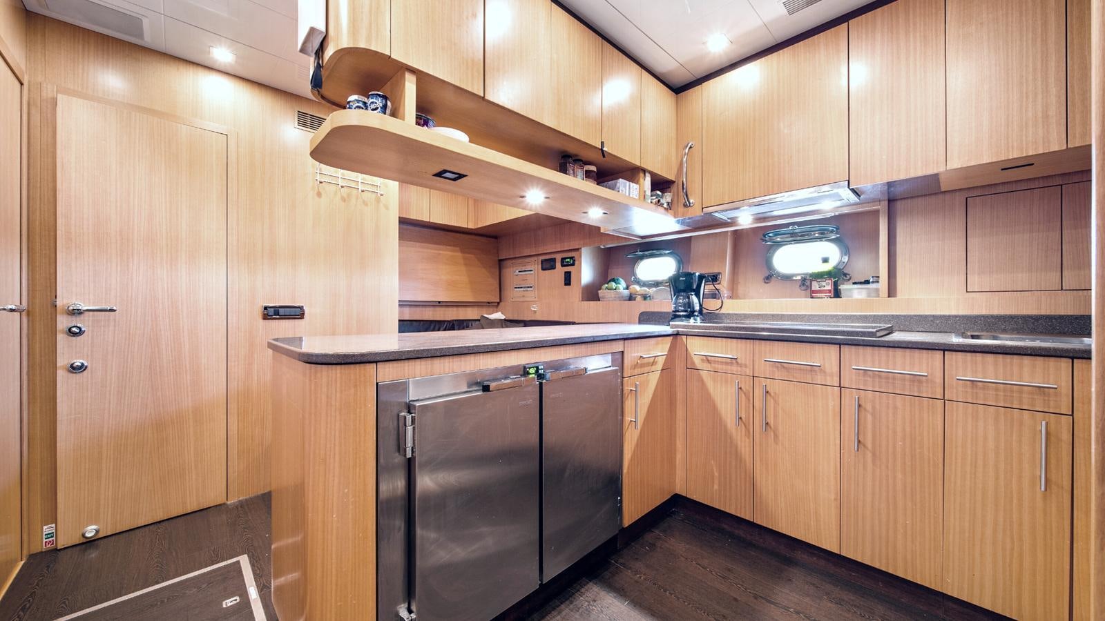 a kitchen with wooden cabinets aboard DAYA Yacht for Sale