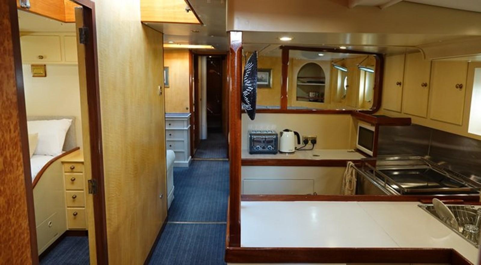 a kitchen with a sink and stove aboard WINDWEAVER OF PENNINGTON Yacht for Sale