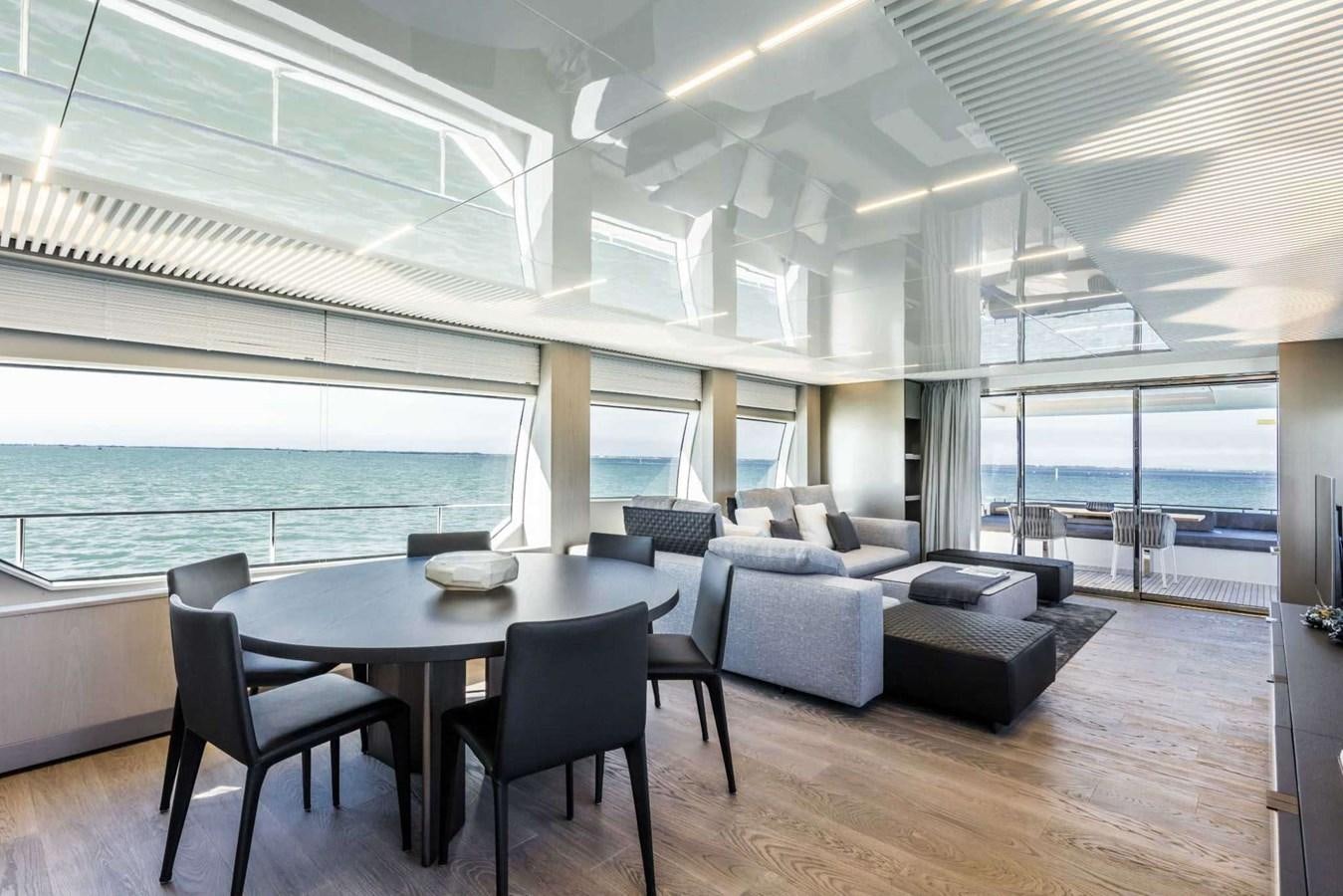 a large room with a table and chairs aboard LADY G Yacht for Sale
