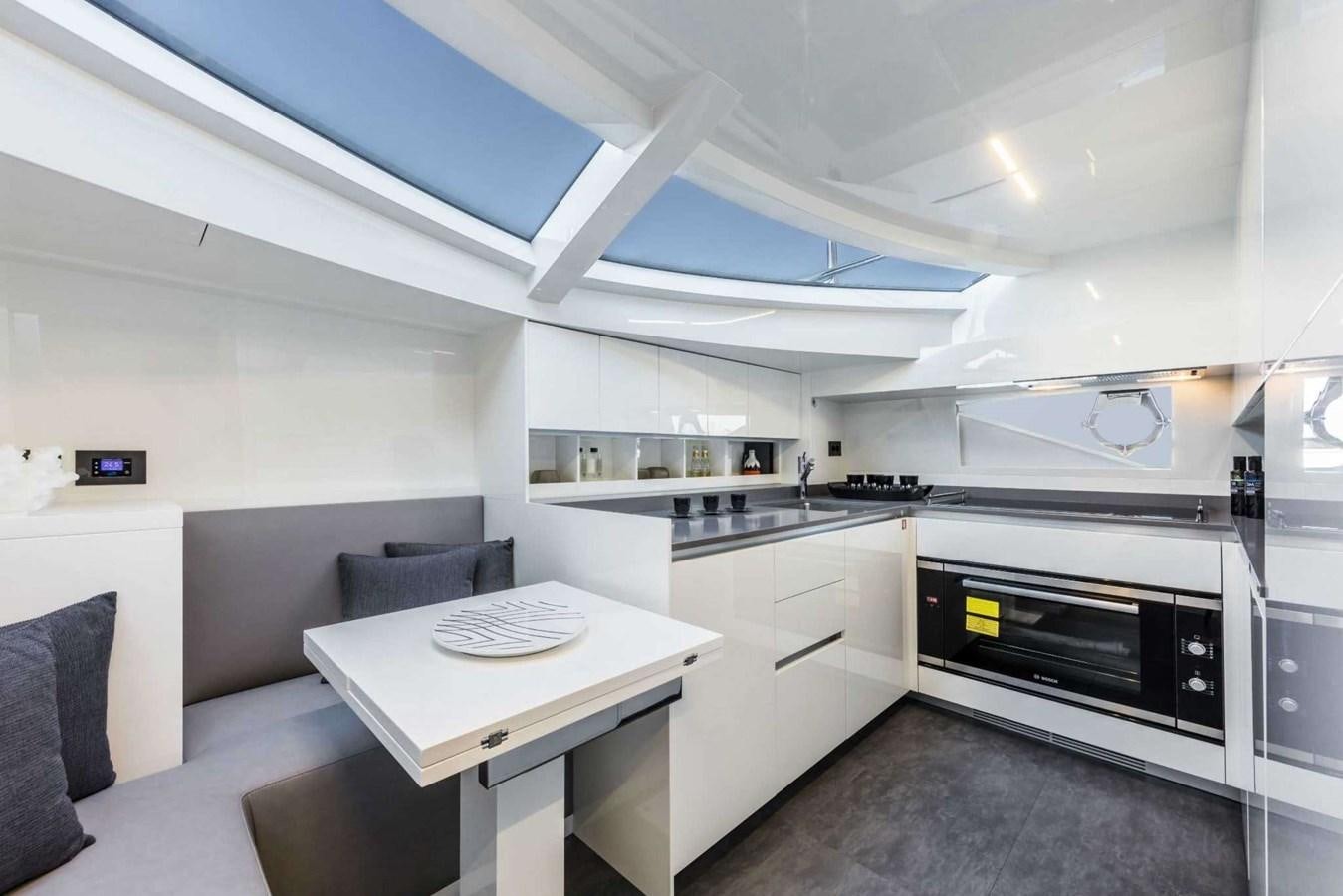 a kitchen with a table and chairs aboard LADY G Yacht for Sale