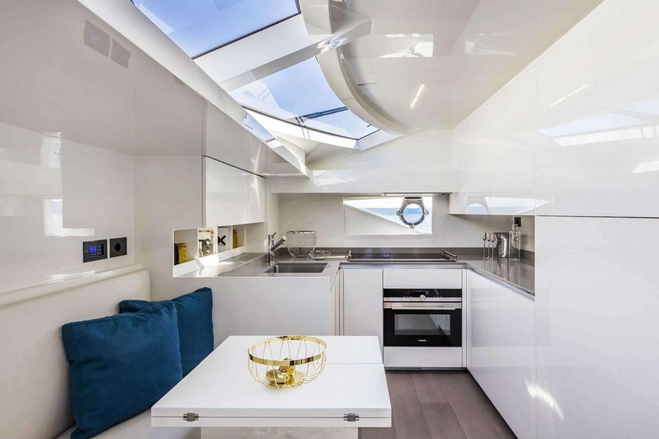 a kitchen with a table and a couch aboard LADY G Yacht for Sale
