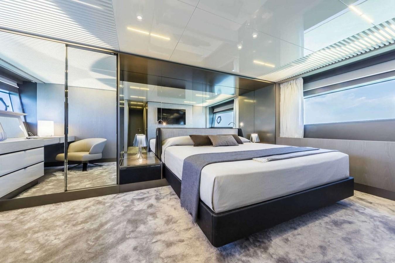 a bedroom with a bed and a chair aboard LADY G Yacht for Sale