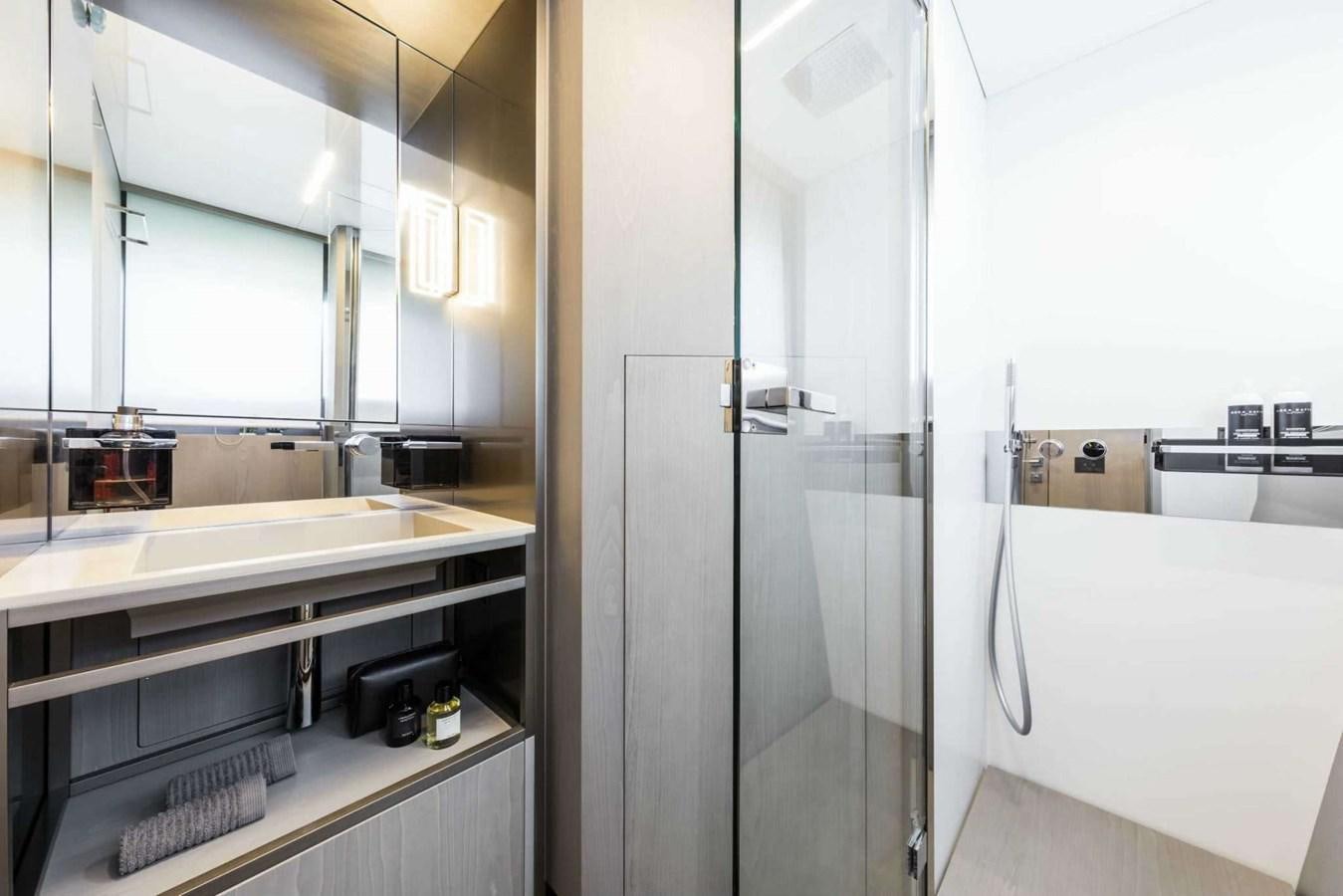 a bathroom with a glass shower aboard LADY G Yacht for Sale