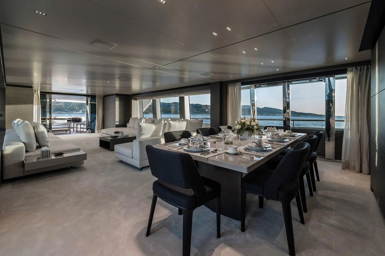 a large room with a table and chairs aboard REGINA Yacht for Sale