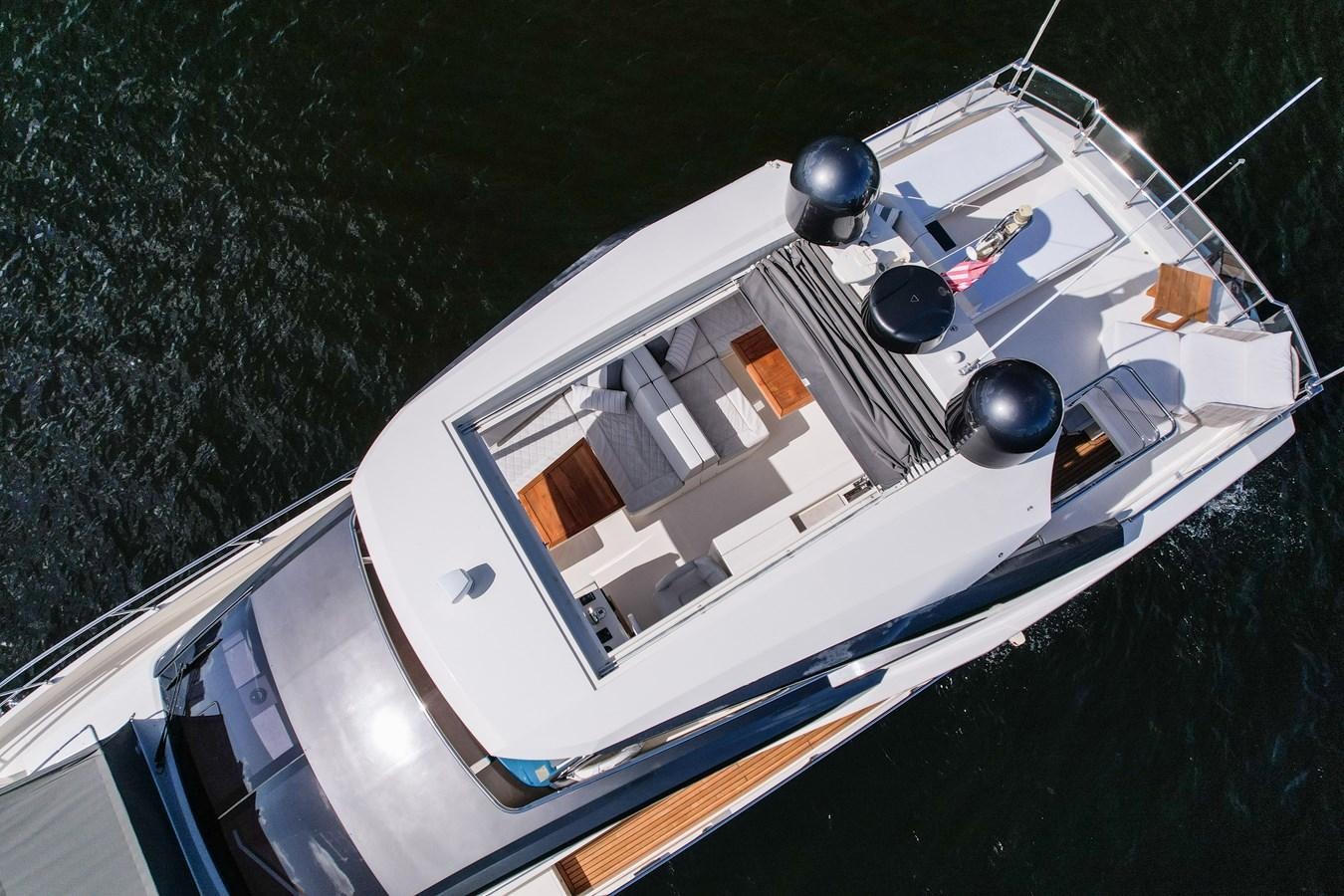 a white boat with a blue circle on it aboard SHEVA Yacht for Sale