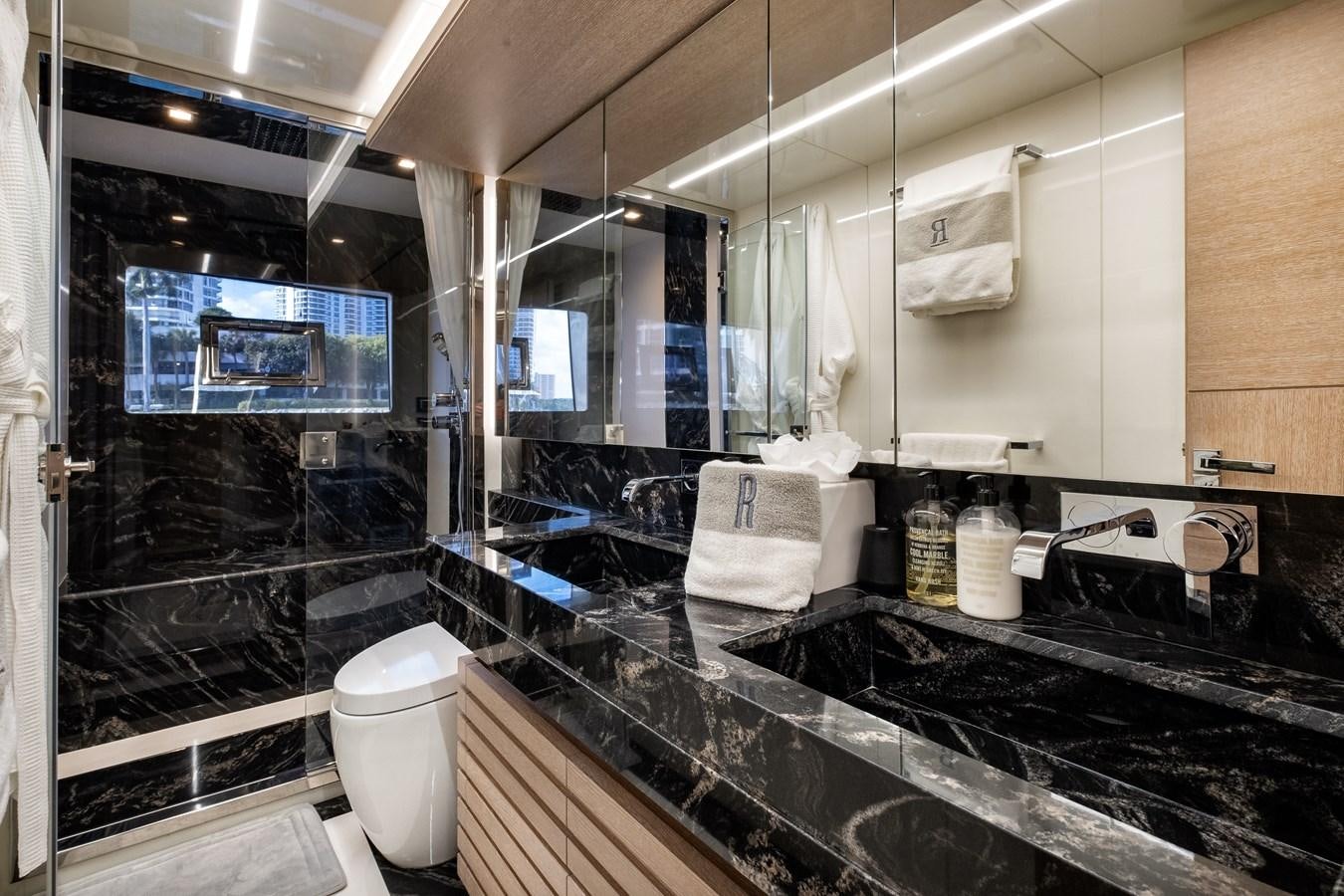 a bathroom with a large mirror aboard SHEVA Yacht for Sale