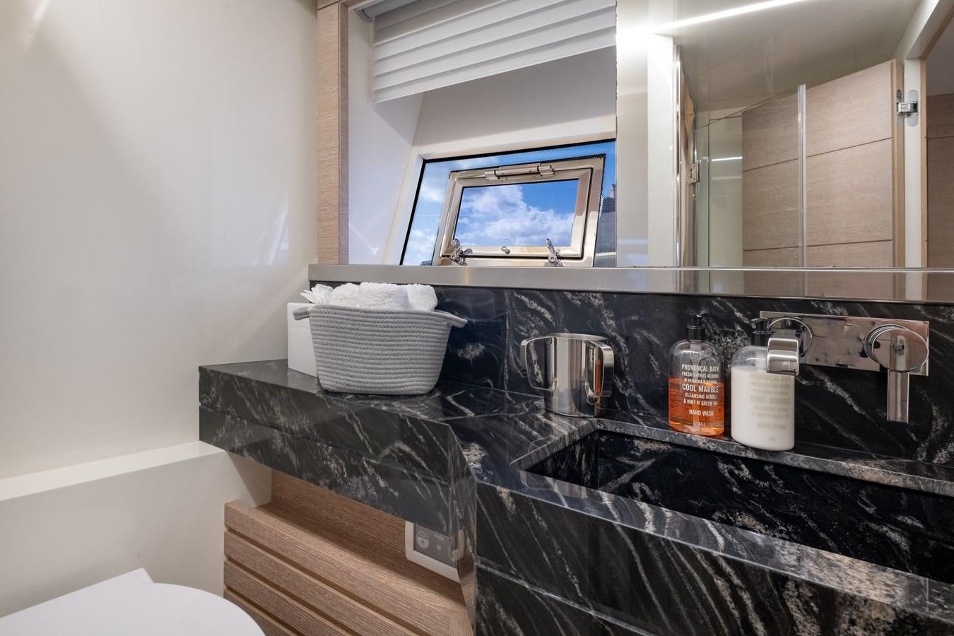 a kitchen counter with a sink and a television on the wall aboard SHEVA Yacht for Sale