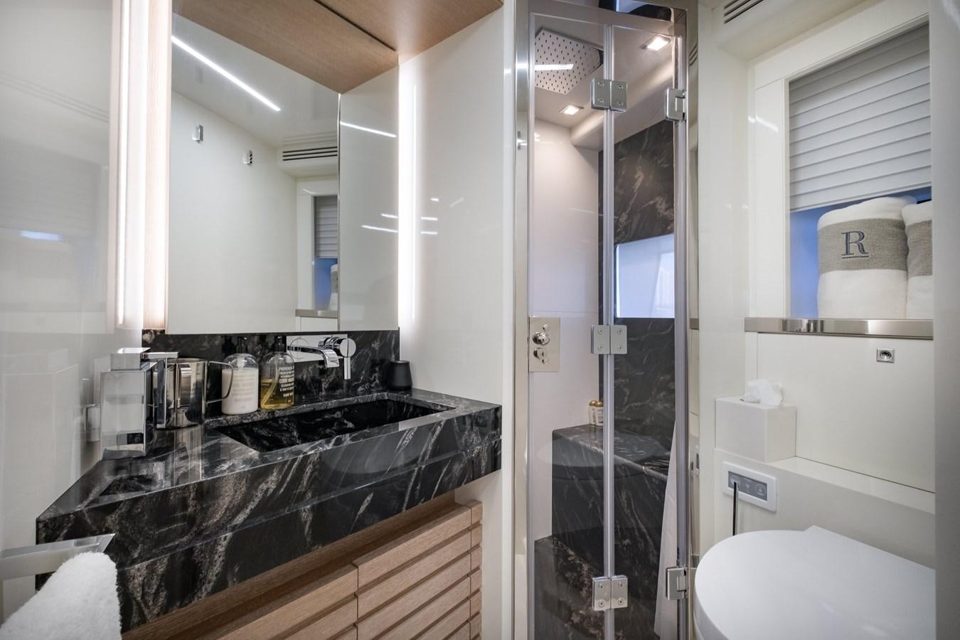 a bathroom with a glass shower aboard SHEVA Yacht for Sale