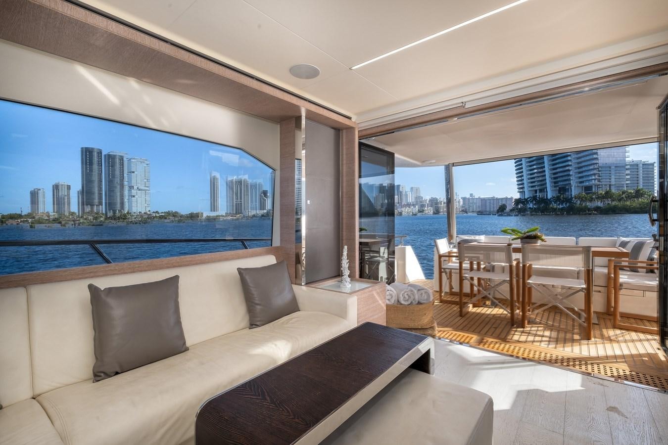 a living room with a large window overlooking a city aboard SHEVA Yacht for Sale