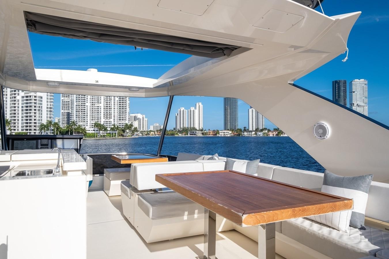 a room with a pool and a large building in the background aboard SHEVA Yacht for Sale