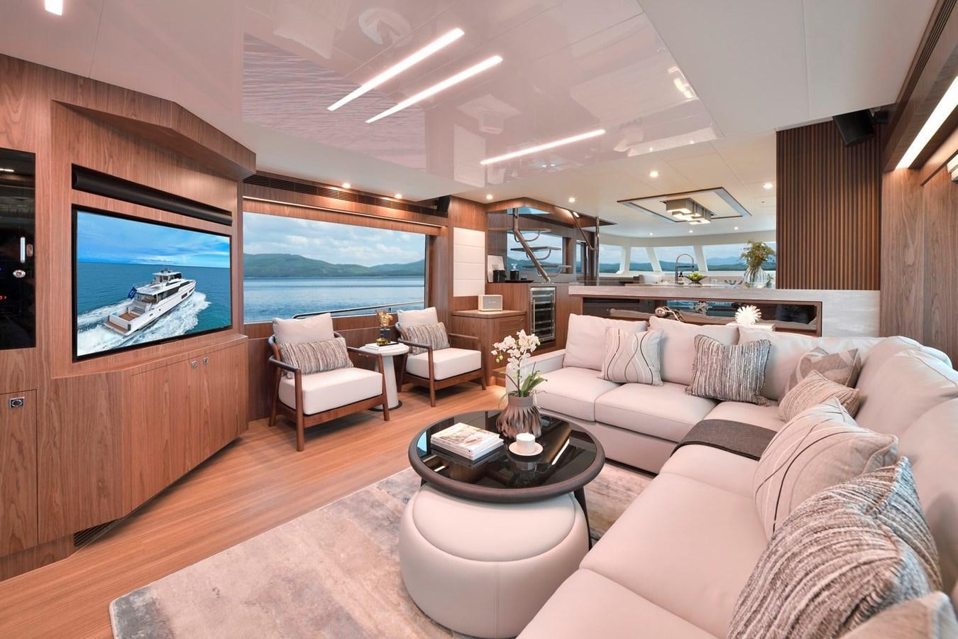 a living room with a large television aboard HORIZON V77 CMY / AVAILABLE NOW Yacht for Sale