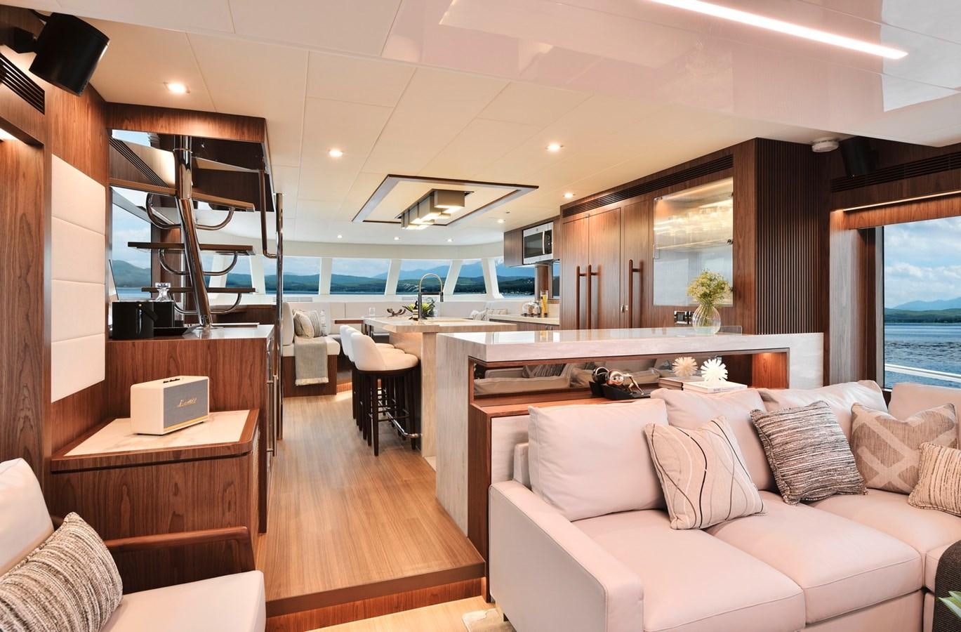 a living room with a large window aboard HORIZON V77 CMY / AVAILABLE NOW Yacht for Sale